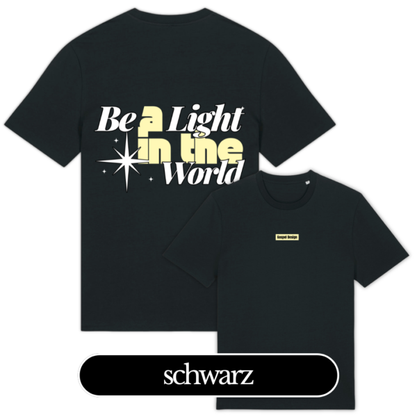 Der junge Mann trägt ein schwarzes T-Shirt mit dem Aufdruck "Be a Light in the World" am Fluss bei S.